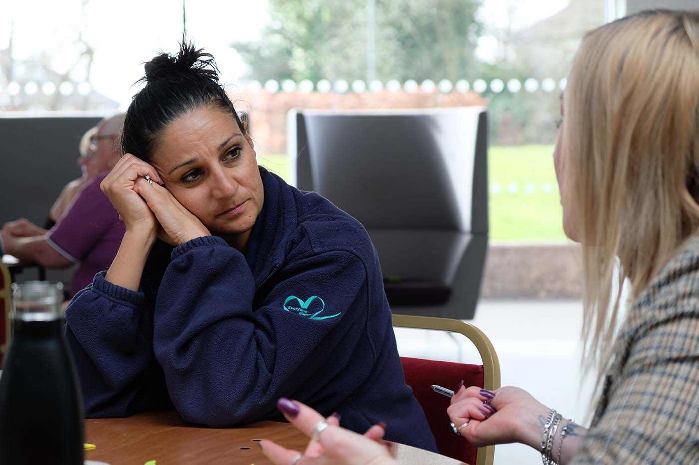 Two women at a community event talking